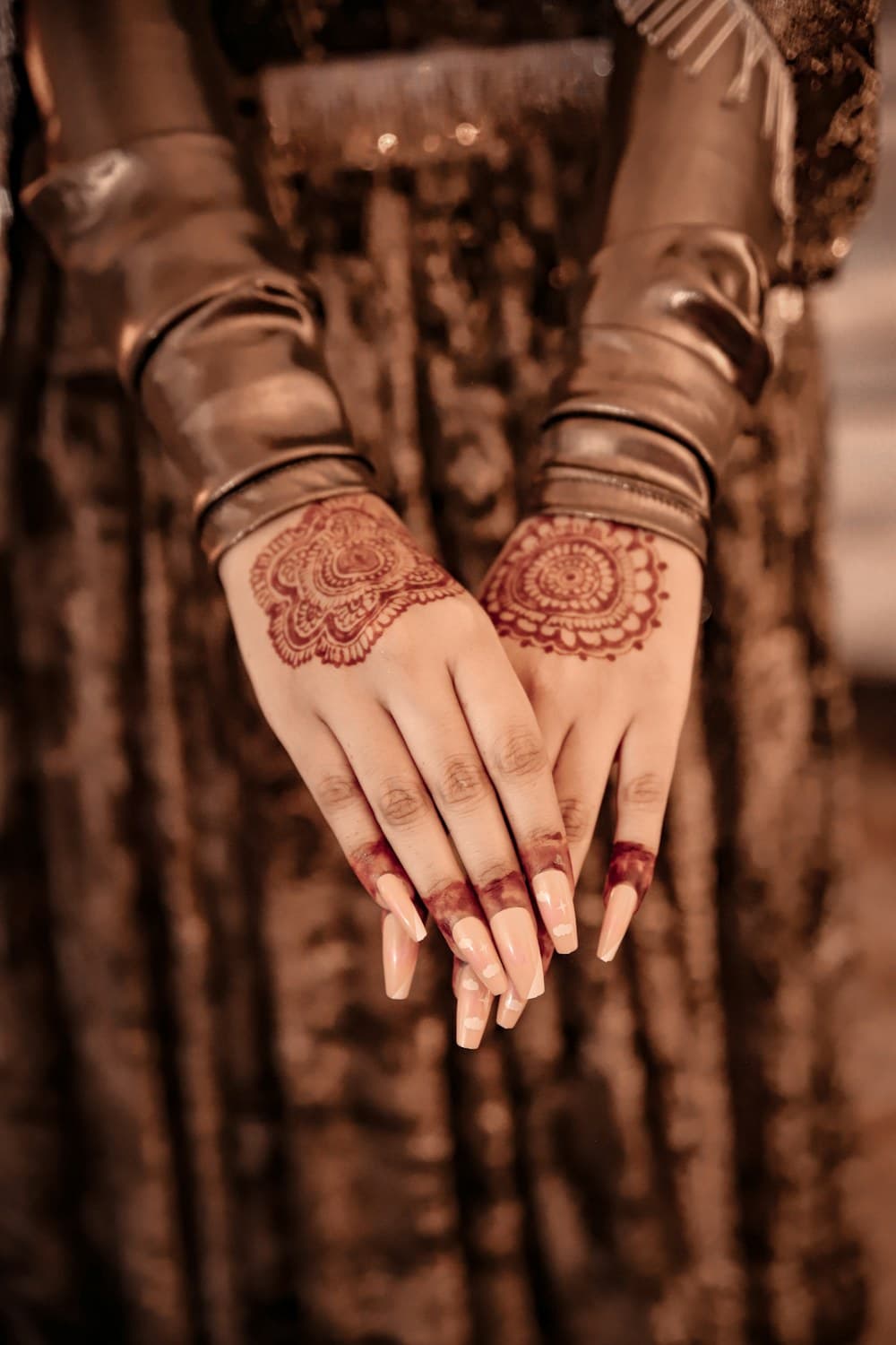 Sample henna patterns on hands, shown as inspiration